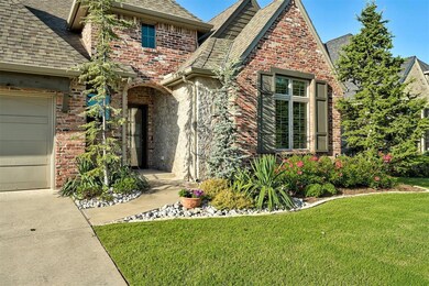 View of front facade with roof with shingles, a front yard, brick siding, and an attached garage