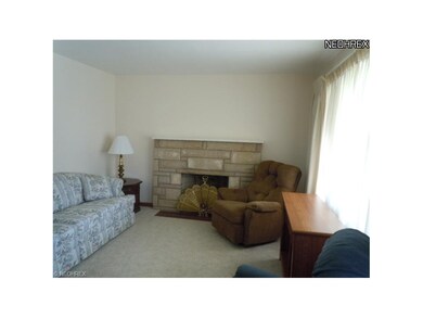 Living room with wood burning fireplace.