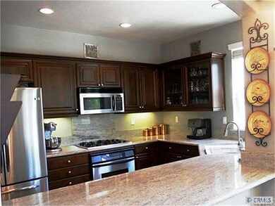 Upgraded Kitchen with Granite Countertops, Dark Wo