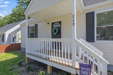 Doorway to property featuring a shingled roof and