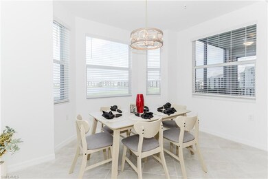 Dining room featuring a chandelier, light tile patterned floors, and baseboards