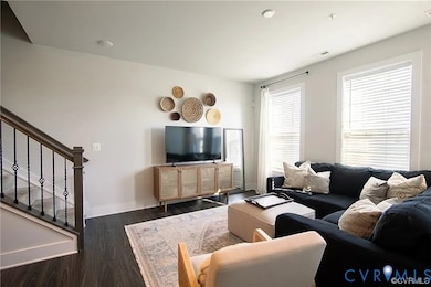 Living area with stairway and dark wood finished floors