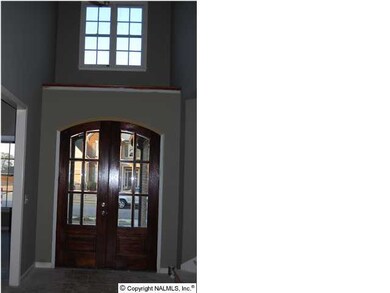 Looking to the front door, Large front door with shelf and window above. Entrance to 2 of the downstairs bedrooms and a jack and jill bath on the left and a half bath plus stair to the 4th bedroom/ bonus room with full bath, walk in closet and storage.