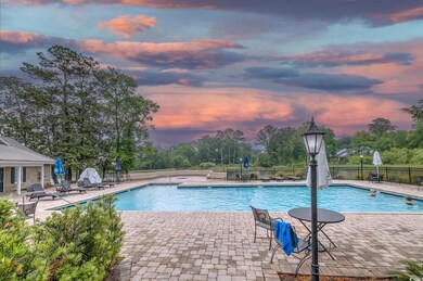 Community pool featuring fence and a patio
