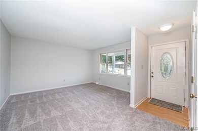 Entryway featuring light carpet