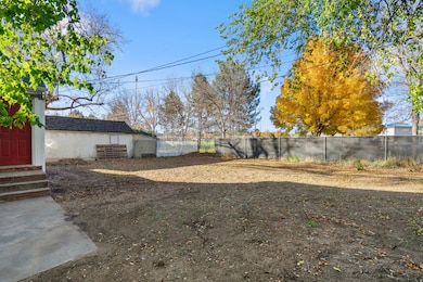 Fenced backyard featuring entry steps