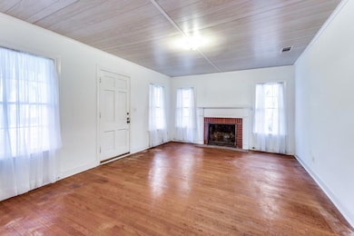 Unfurnished living room featuring wood ceiling, a