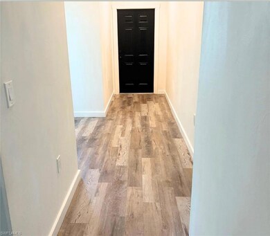 Hall featuring wood finished floors and baseboards