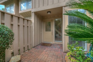 Charming entryway featuring a covered porch with b