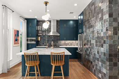 Kitchen with wall chimney range hood, stainless s