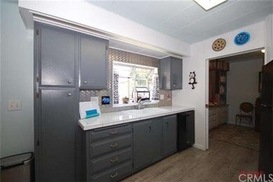 Kitchen features newly painted cabinetry, garden w