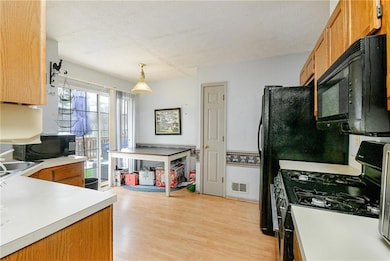 Kitchen featuring gas stove, light hardwood / wood