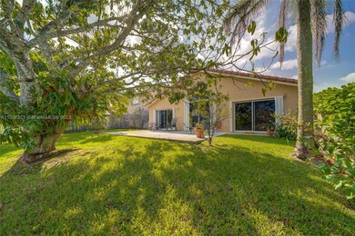 rear patio showing  sliding  glass doorsview of grass patio and sliding glass doors leading to master bedroom ,living room and  family roon