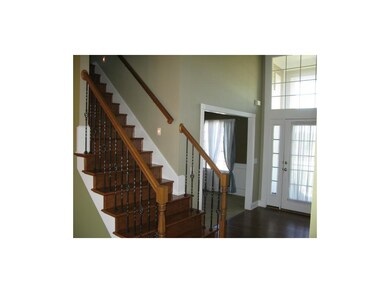 Wrought iron spindles with wooden stairs , entry s