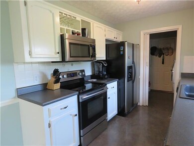 another closer view of Kitchen. Appliances remain. Appliances and countertops & flooring are newish 