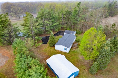 View of home and garage and pole barn