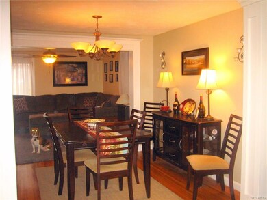 This dining room with gleaming hardwood floors off