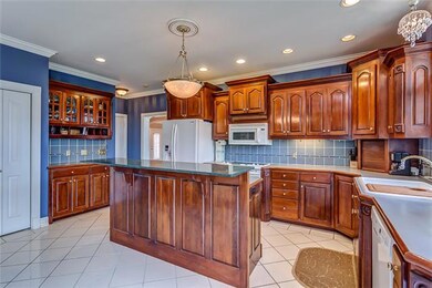 Custom Kitchen with REAL custom, hand-made Cherry Cabinets, tile back splash, and plenty of recessed lighting.
