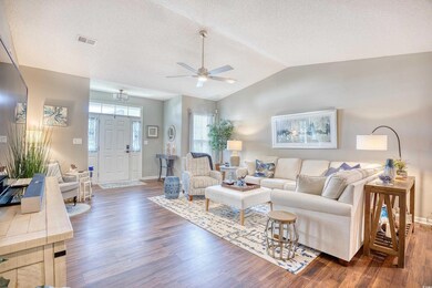 Living room with ceiling fan, dark hardwood / wood