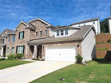 View of front of house featuring driveway, brick s