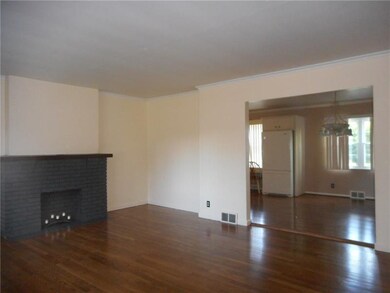 Living Room With Hardwood Flooring & Fireplace