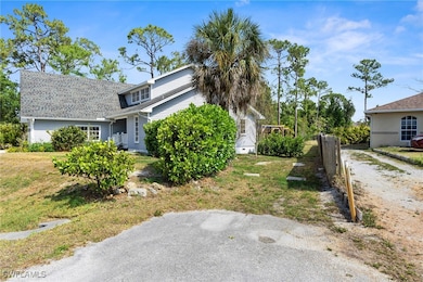 View of property exterior featuring a yard and fen