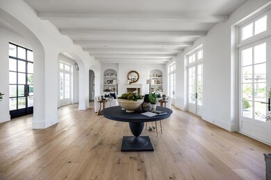 Foyer entrance with arched walkways, beamed ceili