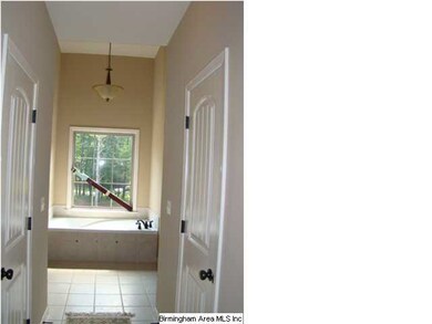 master bath with his and hers closets