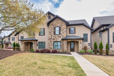 View of front of house featuring stone siding, met