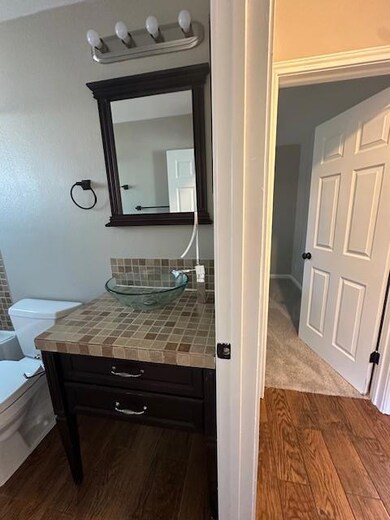 Bathroom with wood finished floors and vanity