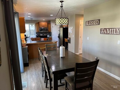 Dining room with light wood finished floors, a textured ceiling, and recessed lighting