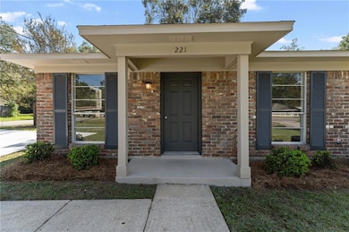 Doorway to property featuring brick siding