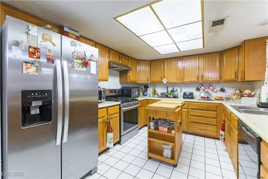 Kitchen featuring stainless steel appliances, ligh