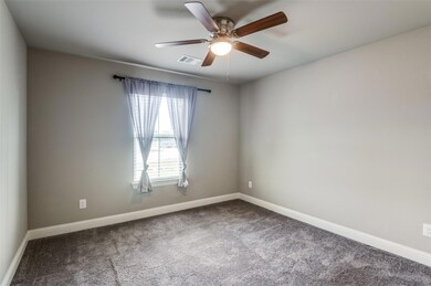 Carpeted empty room with ceiling fan