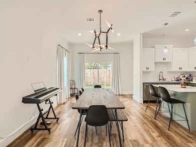 Dining area with light wood-style floors, baseboa