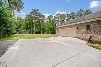 View of home's exterior featuring concrete drivewa