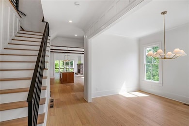 Entrance foyer with large dining room, featuring b