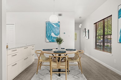 Dining area with light wood-style flooring and ba