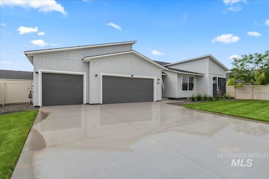View of front facade featuring an attached garage, driveway, and board and batten siding