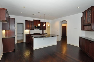 Kitchen with dark countertops, appliances with st