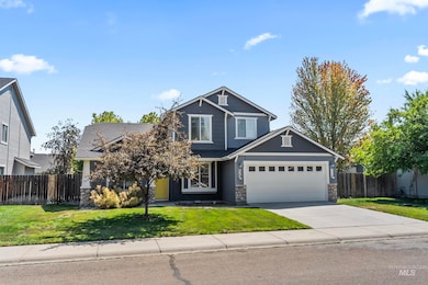Craftsman-style home featuring stone siding, concrete driveway, and an attached garage