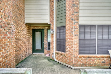 Doorway to property with brick siding