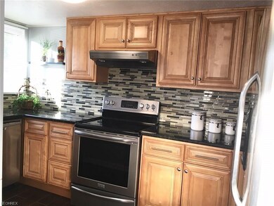 Kitchen contains beautiful maple cabinet and grani