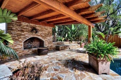 Outside fireplace and entertaining area off of poo