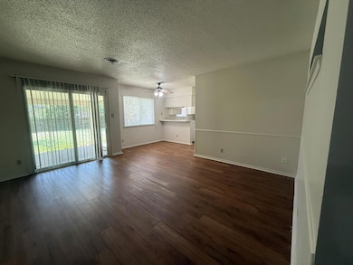 Unfurnished living room featuring ceiling fan, a 