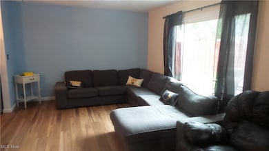 Living area featuring light wood-style floors and baseboards