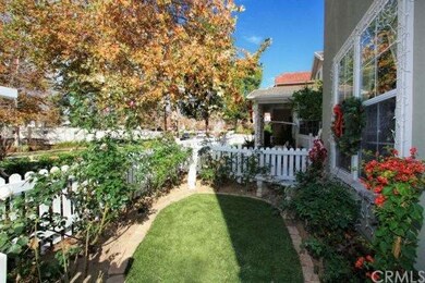 Secondary view of front yard with rose garden and 