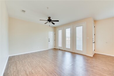 Spare room with ceiling fan and light wood-type fl