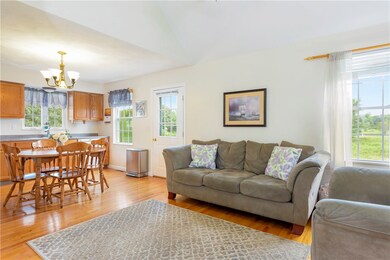 Living room is open to kitchen with hardwood floor