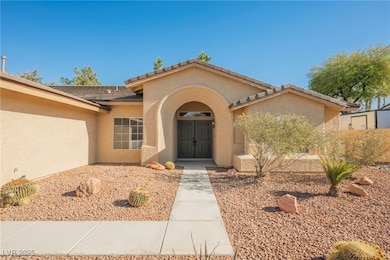 View of exterior entry with stucco siding and a ti